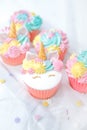 Unicorn cupcake frosting with pastel butter cream.