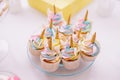 Unicorn fondant cupcakes frosting with butter cream pastel color served on transparent plate