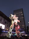 Unicorn Gundam standing in front of the Diver City Tokyo Plaza at Odaiba city at night