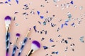 Unicorn ombre makeup brush with party sparkle papers on pastel p