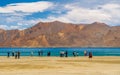 Unidentifed tourists at Pangong Lake, worldÃ¢â¬â¢s highest saltwater lake dyed in blue stand in stark contrast to the arid mountains