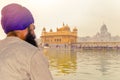 Unidentifiable Punjabi Sikh pilgrim devotee meditating in front of Golden Temple