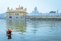 Unidentifiable Punjabi Sikh pilgrim devotee taking bath in front of Golden Temple