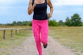 Unidentifiable runner with pink pants jogging Royalty Free Stock Photo