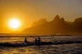 Unidentifiable silhouettes enjoying late afternoon sun rays on Ipanema beach