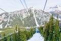 Skiers on Chairlift Up a Ski Slope in the Canadian Rockies Royalty Free Stock Photo