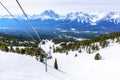 Skiers on Chairlift Up a Ski Slope in the Canadian Rockies Royalty Free Stock Photo