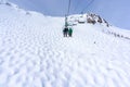 Skiers on Chairlift Up a Ski Slope in the Canadian Rockies Royalty Free Stock Photo