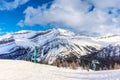 Skiers on Chairlift Up a Ski Slope in the Canadian Rockies Royalty Free Stock Photo