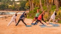 Unidentified adults participating in yoga on the beach