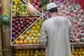 Unidentified Arabian man on the street sell local vegetable and fruits. man selling vegetables on a market. Arab man in the bazaar Royalty Free Stock Photo