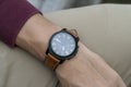 Man wearing black watch with brown leather strap Royalty Free Stock Photo