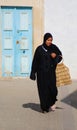 An unidentified bedouin woman wears traditional clothing