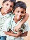 Unidentified best children boys friends smiling standing with hand on shoulder enjoying friendship