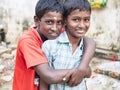 Unidentified best children boys friends smiling standing with hand on shoulder enjoying friendship