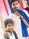 Unidentified best children boys friends smiling standing with hand on shoulder enjoying friendship