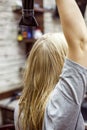 Unidentified blonde woman dries wet hair with Hairdryer