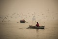 Unidentified boatman rows his boat on the Ganges Royalty Free Stock Photo