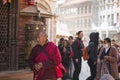 Unidentified Buddhist monk near stupa Boudhanath. Stupa is one of the largest in the world