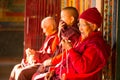 Unidentified Buddhist monks near stupa Boudhanath. Stupa is one of the largest in the world