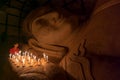 Unidentified Burmese girl praying with candle light in a Buddihist temple on January 5, 2011 in Bagan