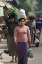 An unidentified Burmese woman carrying the rice on the dead in market at bagan, Myanmar