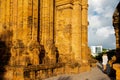 Unidentified Caucasian tourist standing between Po Nagar Cham temple tower and modern Nha Trang downtown skyline background,