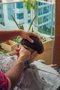 Unidentified child getting haircut at the apartment home balcony