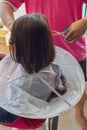 Unidentified child getting haircut. Closeup on hair dust