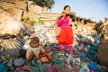 Unidentified child is sitting while her parents are working on dump, Dec 22, 2013 in Kathmandu, Nepal.