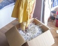 An unidentified child is standing inside the shredded paper box to compress it. Recycling paper Royalty Free Stock Photo