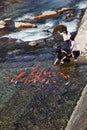 Unidentified children feeding fish