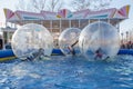 Unidentified children play having fun inside large tarsparent balls on the water Royalty Free Stock Photo