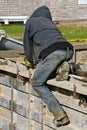 A concrete worker levels the wet mud while straddling the forms.