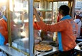 Unidentified Cook frying Turkish Dessert Lokma aka Honey Balls at Eminonu on his cart in Istanbul