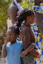 Unidentified Diola girls with braids stand back to back in Kasc