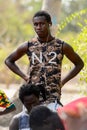 Unidentified Diola man with headphones stands in Kaschouane vil