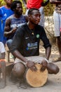 Unidentified Diola man plays on drums in Kaschouane village. Di