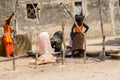 Unidentified Diola women work on the street in Kaschouane villa