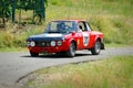 Unidentified drivers on a black and red vintage Lancia Fulvia racing car