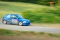 Unidentified drivers on a blue vintage Peugeot 106 racing car