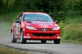 Unidentified drivers on a red vintage Peugeot 106 racing car