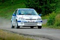 Unidentified drivers on a white vintage Peugeot 106 racing car