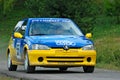 Unidentified drivers on a yellow and blue vintage Peugeot 106 racing car