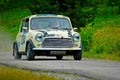 Unidentified drivers on a yellow vintage Mini Cooper racing car Royalty Free Stock Photo