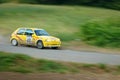 Unidentified drivers on a yellow vintage Peugeot 105 racing car