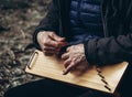 Unidentified elderly man plays the harp. Hands closeup