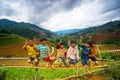 Unidentified ethnic kids relaxing on the mountain when his parents are working on the terraces.