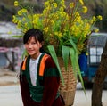 Unidentified ethnic minority kids with baskets of rapeseed flower in Hagiang, Vietnam Royalty Free Stock Photo