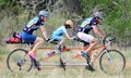 Unidentified family members riding a custom bicycle.